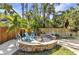 Backyard with a stone fire pit and Adirondack chairs at 107 Sunset Dr, Nokomis, FL 34275