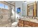 Elegant bathroom featuring a glass-enclosed shower, wood cabinets, and granite countertops at 107 Sunset Dr, Nokomis, FL 34275