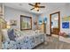 Cozy bedroom featuring a ceiling fan, a window with blinds, and an ensuite bathroom at 107 Sunset Dr, Nokomis, FL 34275