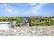 Water access dock with pathway through a hedge at 107 Sunset Dr, Nokomis, FL 34275