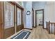 Inviting foyer featuring wood-look floors, decorative double doors, and modern trim at 107 Sunset Dr, Nokomis, FL 34275