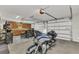 Spacious garage featuring a motorcycle, custom cabinets, and a convenient table with seating at 107 Sunset Dr, Nokomis, FL 34275