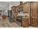 Modern kitchen with stainless steel appliances, wooden cabinets, and a mosaic tile backsplash at 107 Sunset Dr, Nokomis, FL 34275