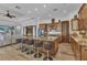 Open kitchen featuring a large island with seating, stainless steel appliances, and beautiful wood cabinetry at 107 Sunset Dr, Nokomis, FL 34275