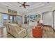 Inviting living room featuring cozy seating, a built-in entertainment center, and water views at 107 Sunset Dr, Nokomis, FL 34275