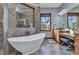 Luxurious main bathroom with a soaking tub, walk-in shower, and vanity area at 107 Sunset Dr, Nokomis, FL 34275