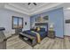 Comfortable main bedroom featuring stylish decor, wood-look floors, and a tray ceiling at 107 Sunset Dr, Nokomis, FL 34275