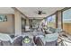 Relaxing covered patio with plush seating, a fire pit, and beautiful views at 107 Sunset Dr, Nokomis, FL 34275