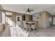 Covered outdoor patio features a dining area and a mounted TV for entertainment at 107 Sunset Dr, Nokomis, FL 34275
