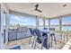 Outdoor patio with a bar and dining table overlooks waterfront at 107 Sunset Dr, Nokomis, FL 34275