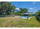 Inviting backyard pool with a home in the background, surrounded by mature trees at 11015 S County Road 39, Lithia, FL 33547