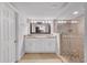 Bathroom with double vanity, granite countertops, and modern glass shower at 11015 S County Road 39, Lithia, FL 33547