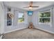 Cozy bedroom with natural light from windows, a ceiling fan, and carpeted floors at 11015 S County Road 39, Lithia, FL 33547