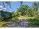 Exterior shot of a driveway leading toward a home, with surrounding trees and shrubbery at 11015 S County Road 39, Lithia, FL 33547