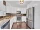 Modern kitchen featuring stainless steel appliances, white cabinetry, and a stylish tile backsplash at 11015 S County Road 39, Lithia, FL 33547