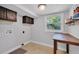 Well-lit laundry room with upper cabinets and utility sink at 11015 S County Road 39, Lithia, FL 33547