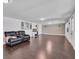 Bright living room with hardwood floors, a large couch, and access to the backyard at 11015 S County Road 39, Lithia, FL 33547