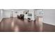 Large living room with hardwood floors and a black leather couch at 11015 S County Road 39, Lithia, FL 33547