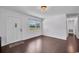 Bright living room with hardwood floors and a large window at 11015 S County Road 39, Lithia, FL 33547