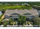 Aerial view of a townhome complex surrounded by lush greenery and a serene pond at 11029 Winter Crest Dr Dr, Riverview, FL 33569