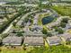 Aerial view of the community showcasing pond, green trees, parking and condo buildings with colorful exteriors at 11029 Winter Crest Dr Dr, Riverview, FL 33569