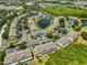 Community aerial view featuring ponds, lush trees, parking, and condo buildings with green and gray exteriors at 11029 Winter Crest Dr Dr, Riverview, FL 33569