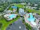 Drone view showing community amenities featuring pools, a playground, tennis courts, and landscaping at 11029 Winter Crest Dr Dr, Riverview, FL 33569