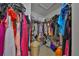 Spacious walk-in closet with ample hanging storage and a variety of colorful clothes and bags at 11029 Winter Crest Dr Dr, Riverview, FL 33569
