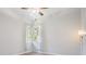 Bedroom with neutral paint and a view to the outside at 1119 Hounds Run, Safety Harbor, FL 34695