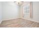 Neutral bedroom with a ceiling fan and shuttered window at 1119 Hounds Run, Safety Harbor, FL 34695