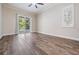 Cozy bedroom with wood-look flooring and a sliding glass door leading to the pool area at 1119 Hounds Run, Safety Harbor, FL 34695