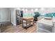 Bright kitchen features stainless steel appliances, white cabinets, and a butcher block island at 1119 Hounds Run, Safety Harbor, FL 34695