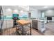 Contemporary kitchen with white cabinets, stainless steel appliances, a kitchen island and beautiful backsplash at 1119 Hounds Run, Safety Harbor, FL 34695