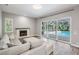 Cozy living room with fireplace, comfortable seating, and views of the pool at 1119 Hounds Run, Safety Harbor, FL 34695