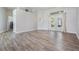 Spacious living area features wood-look floors and natural light flowing in from the French doors at 1119 Hounds Run, Safety Harbor, FL 34695