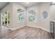 Bright sitting area with wood floors, natural light and access to screened porch at 1119 Hounds Run, Safety Harbor, FL 34695