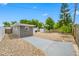 Landscaped backyard featuring a concrete patio, rock groundcover, and detached garage for extra storage at 1120 45Th N St, St Petersburg, FL 33713