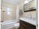 Bathroom featuring tile, a bathtub with shower, a modern vanity, mirror, and toilet at 1120 45Th N St, St Petersburg, FL 33713