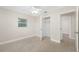 Bright bedroom with neutral paint and flooring, ceiling fan, closet, and natural light from windows at 1120 45Th N St, St Petersburg, FL 33713