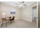 Comfortable bedroom with a ceiling fan, neutral walls, and a desk area at 1120 45Th N St, St Petersburg, FL 33713