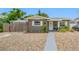 Charming single-story home with gray exterior, white trim, stone landscaping, and a welcoming front door at 1120 45Th N St, St Petersburg, FL 33713
