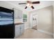 Bright kitchen with black appliances, gray cabinets, and a view into an adjacent room at 1120 45Th N St, St Petersburg, FL 33713
