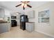 Spacious kitchen with black appliances, gray cabinets, ceiling fan and natural light from large windows at 1120 45Th N St, St Petersburg, FL 33713