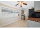 Bright kitchen with black appliances, gray cabinets, ceiling fan and natural light from large windows at 1120 45Th N St, St Petersburg, FL 33713