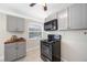 Kitchen with stainless steel appliances, wood countertop, and gray cabinetry at 1120 45Th N St, St Petersburg, FL 33713