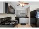 Cozy kitchen featuring black appliances, gray cabinets, modern countertops, and a stylish backsplash at 1120 45Th N St, St Petersburg, FL 33713