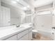 Bright bathroom featuring a vanity, large mirror, and a shower-tub combination at 11226 Thicket Ct, Tampa, FL 33624