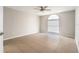 Bright bedroom with a ceiling fan and large window providing ample natural light at 11226 Thicket Ct, Tampa, FL 33624
