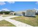 Well-manicured front lawn with a charming single-story home featuring a two-car garage at 11226 Thicket Ct, Tampa, FL 33624