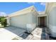 Inviting home featuring a two-car garage and decorative walkway leading to the front entrance at 11226 Thicket Ct, Tampa, FL 33624